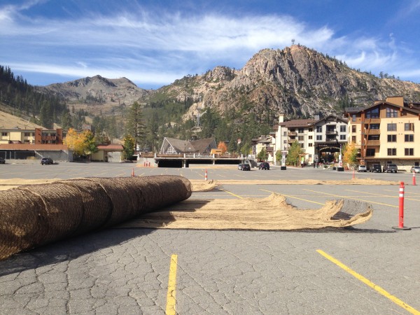 Burlap and mesh sheets in the Squaw parking lot await placement by helicopter onto lower mountain ski runs.  